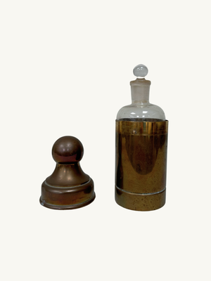 Glass bottle with brass holder