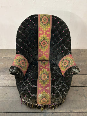 Black velvet buttoned armchair