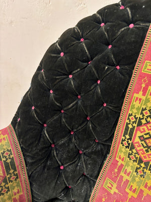 Black velvet buttoned armchair