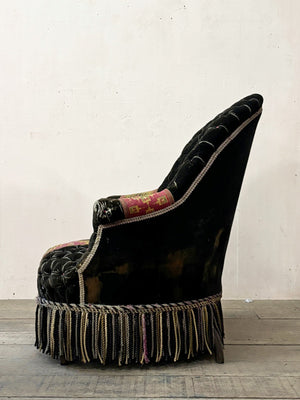Black velvet buttoned armchair