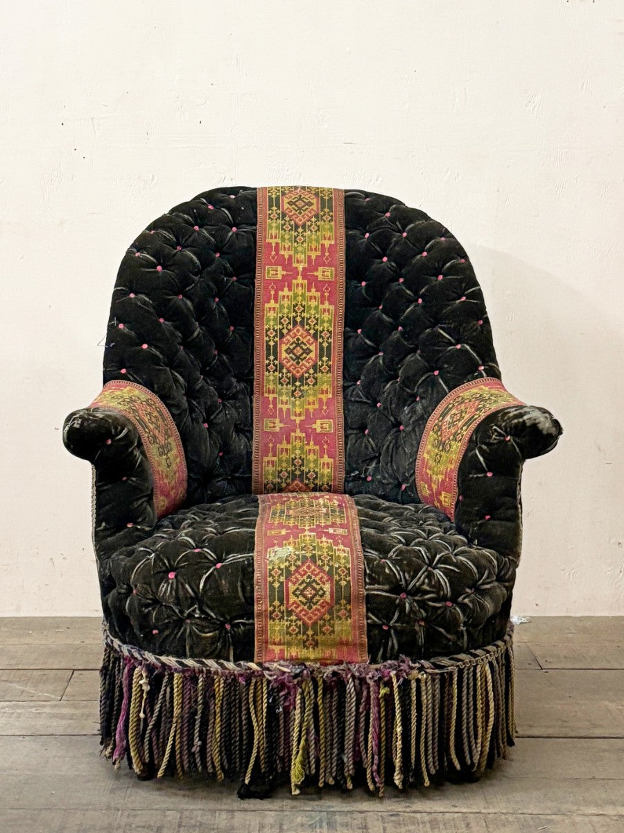 Black velvet buttoned armchair