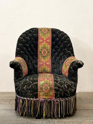 Black velvet buttoned armchair