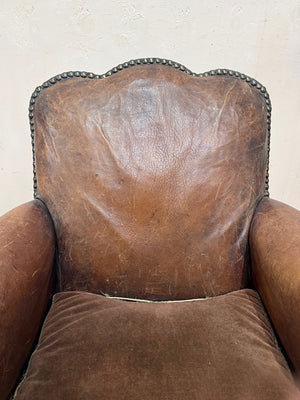 Leather studded club armchairs