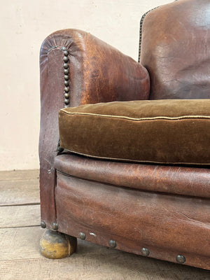 Leather studded club armchairs