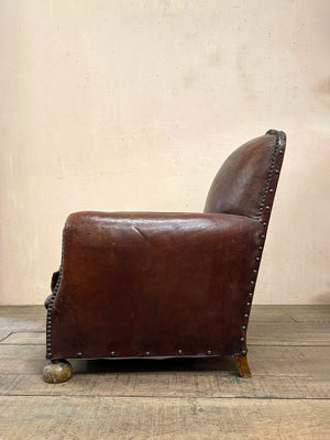 Leather studded club armchairs
