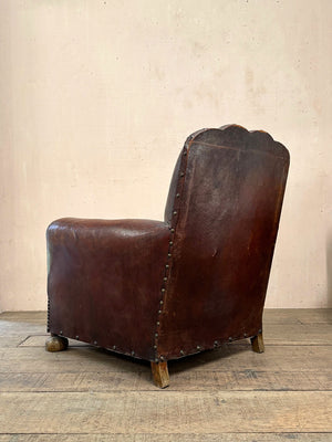 Leather studded club armchairs
