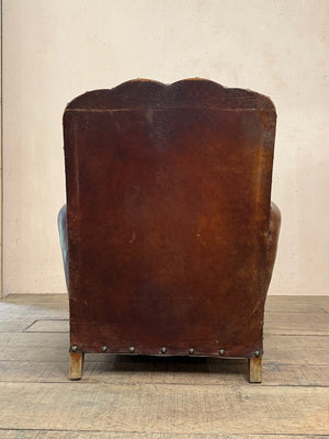 Leather studded club armchairs