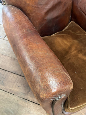 Leather studded club armchairs