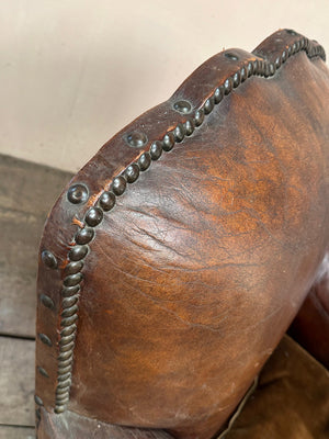 Leather studded club armchairs