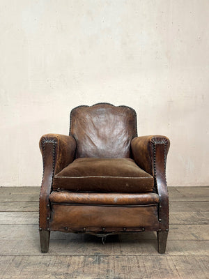 Leather studded club armchairs