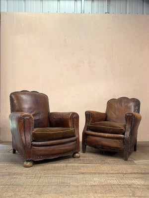 Leather studded club armchairs