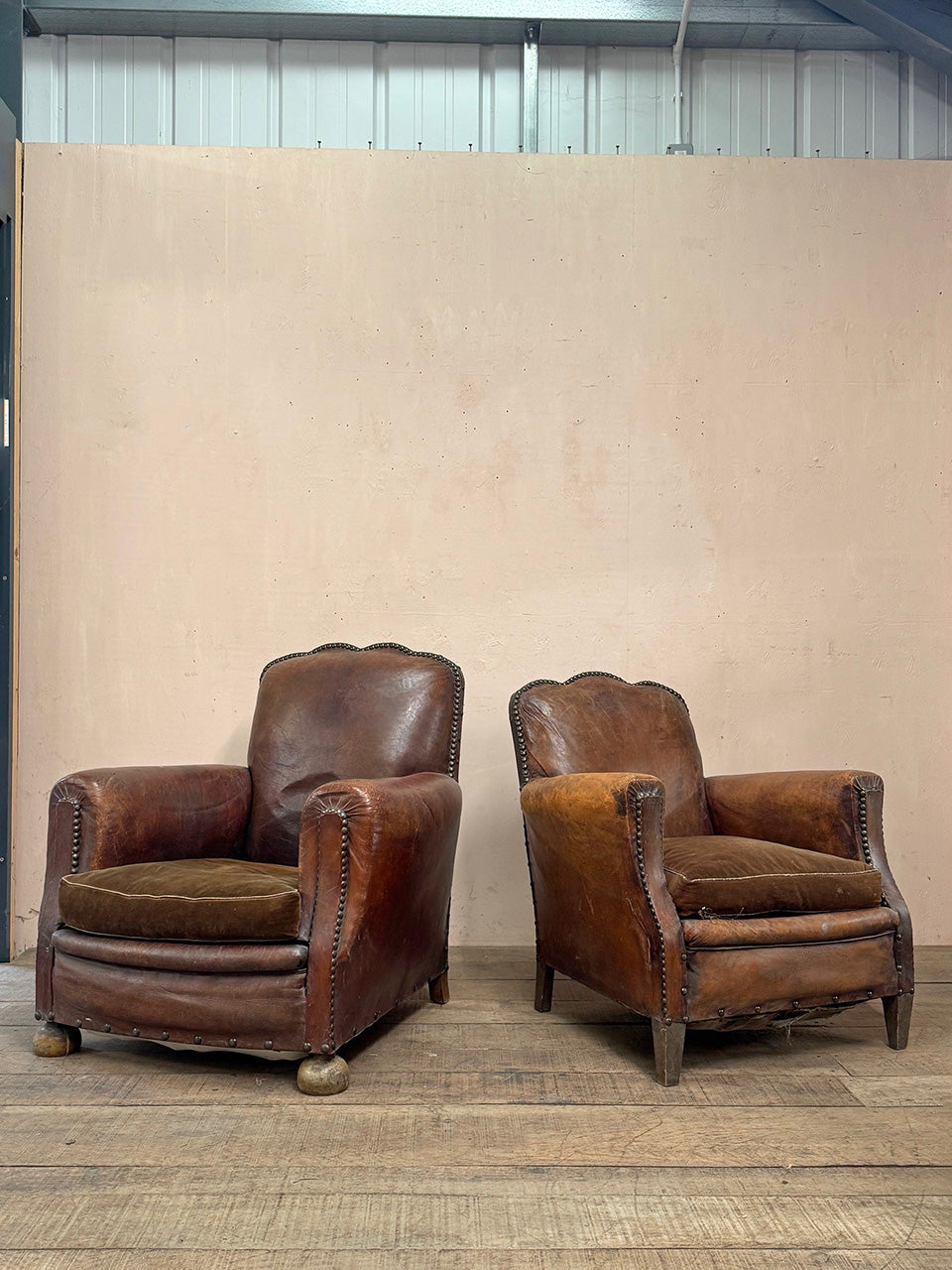 Leather studded club armchairs