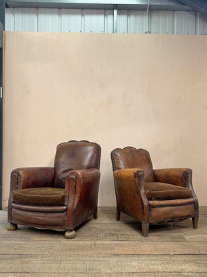 Leather studded club armchairs