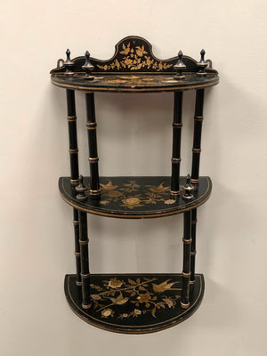 Ebonised and gilded wall shelf