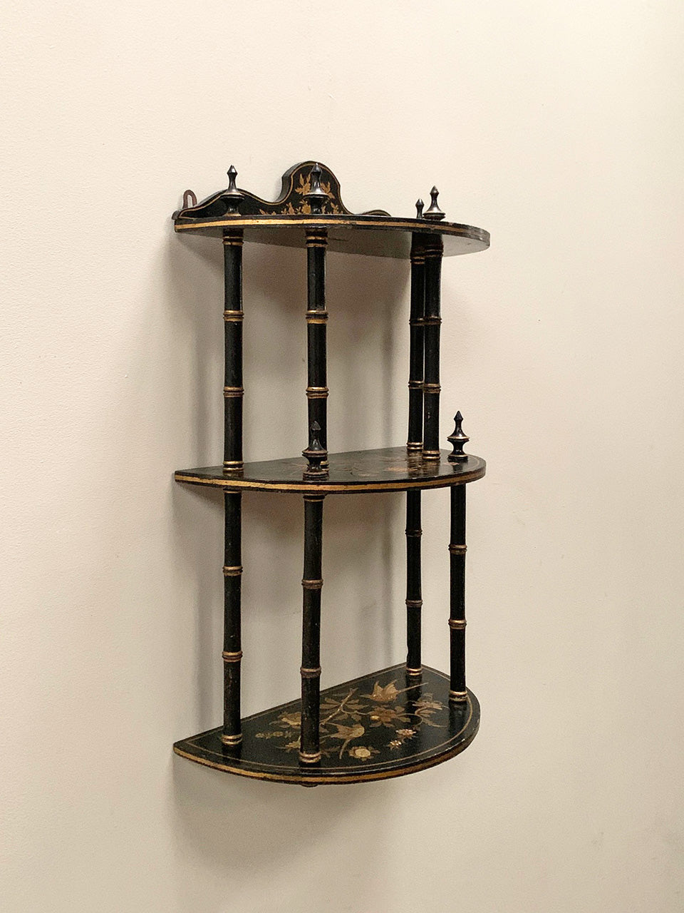 Ebonised and gilded wall shelf
