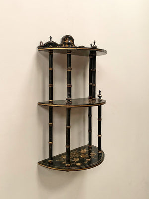 Ebonised and gilded wall shelf