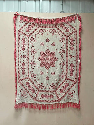 Pink tasseled bedspread