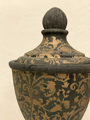 Pair of black and gold painted terracotta urns