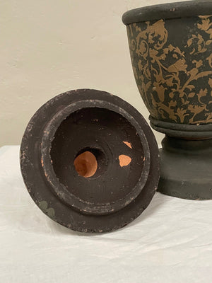 Pair of black and gold painted terracotta urns