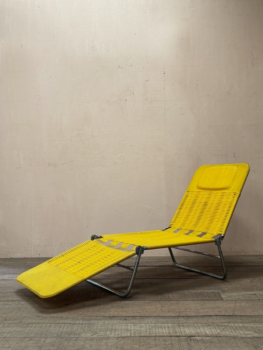 Yellow plastic sun lounger