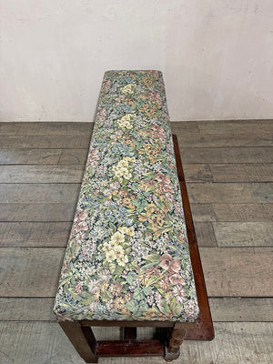 Upholstered bench with folding footstool