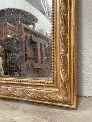 Tall gilded mirror with cherub crest