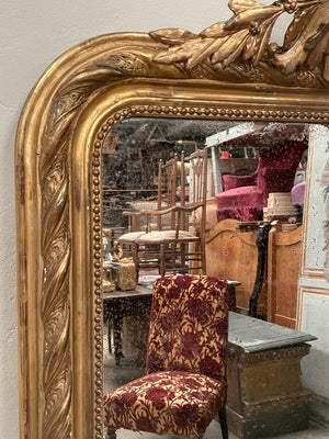 Tall gilded mirror with cherub crest