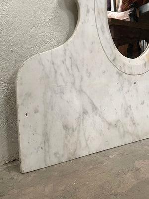 Oval mirror set in marble