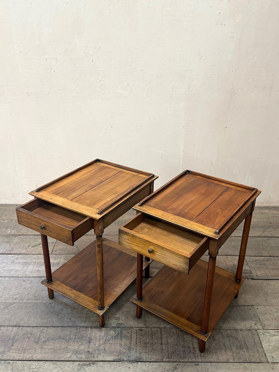 Pair of tiered side tables with drawers