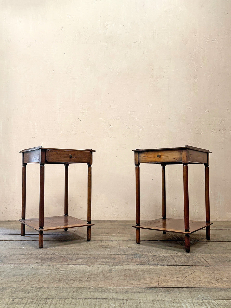 Pair of tiered side tables with drawers