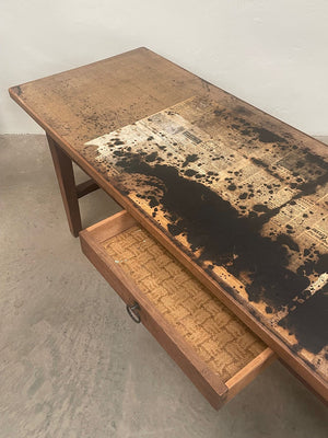 Long table with newspaper print top