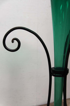 Green glass vase in stand