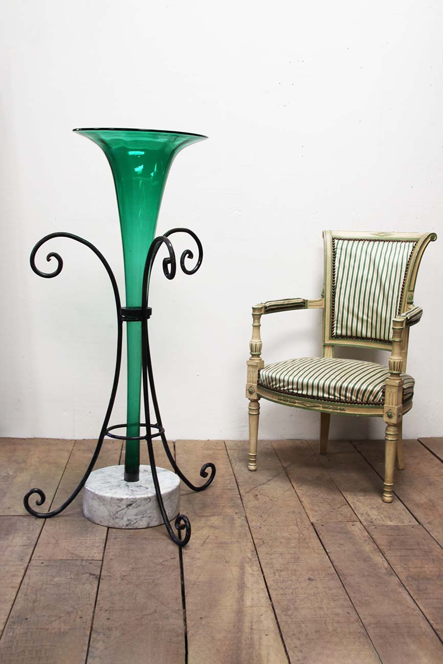 Green glass vase in stand